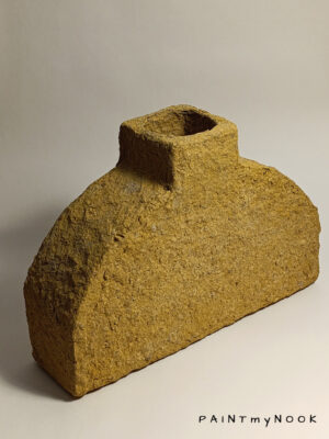 decorative vase made out of papier mache, in a mustard yellow color