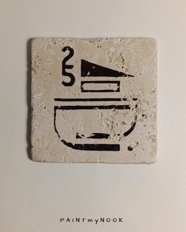 Travertine coaster with a dark brown modernist graphic printed on it