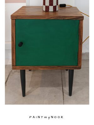 Lucky Locker A wooden upcycled bedside table with a green colored door and black legs.