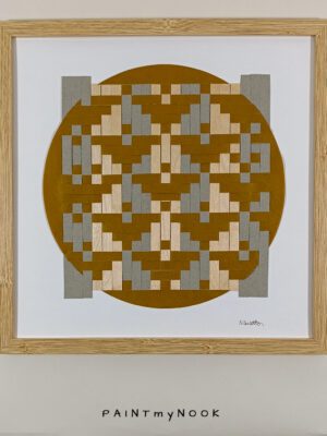 Framed wall decor featuring a yellow ochre paperweaving project