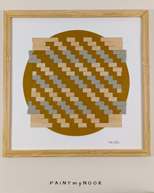 Framed wall decor featuring a yellow ochre paperweaving project