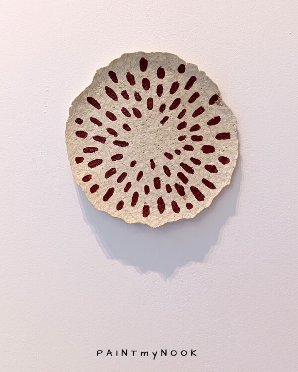 Russettas Seeds plate A paper mache decorative plate with red seeds painted on it