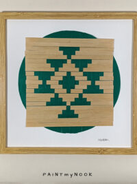 Framed wall decor featuring a green colored paperweaving project