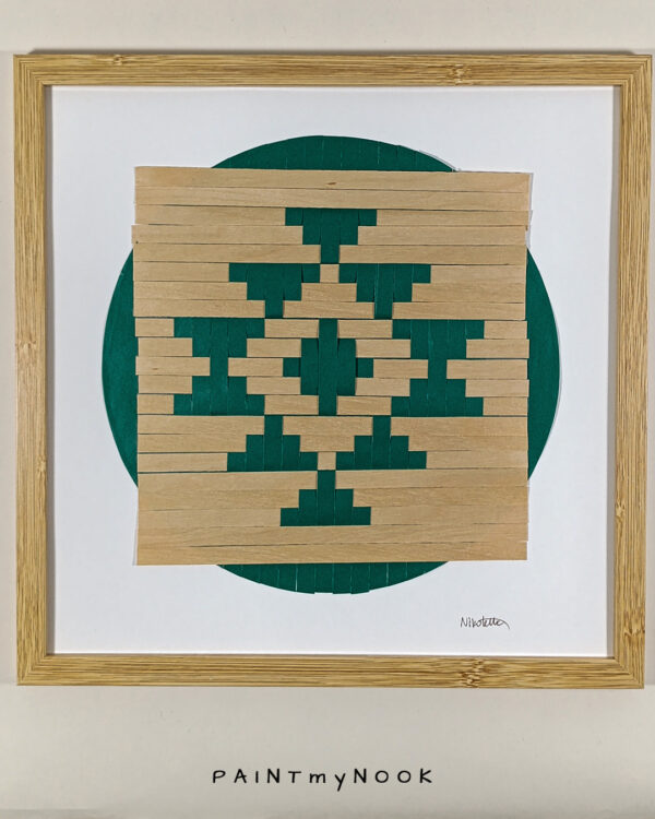 Framed wall decor featuring a green colored paperweaving project
