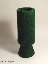 A deep green cylindrical papier mache vase with foot
