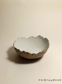 A light colored Papier mâché bowl