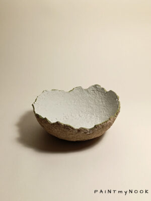 A light colored Papier mâché bowl