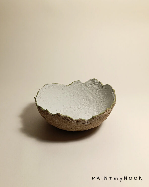 A light colored Papier mâché bowl