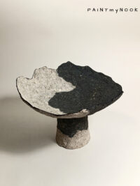A two colored papier mache bowl with foot