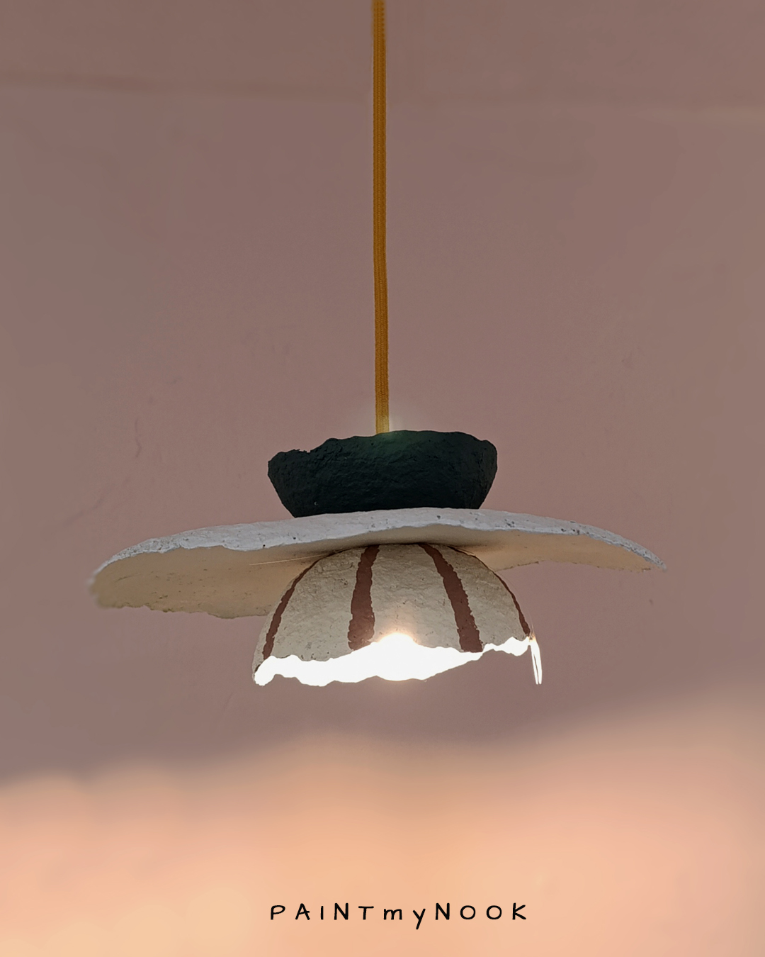 A multi-colored paper mache lamp