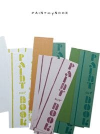 Paper bookmarks in various colors with a lettering linoprint