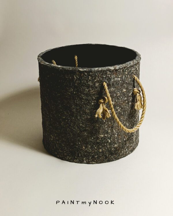 A planter cover in a granite grey color