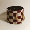 papier mache cylindrical planter cover with a check pattern in cherry red and beige colors κασπω