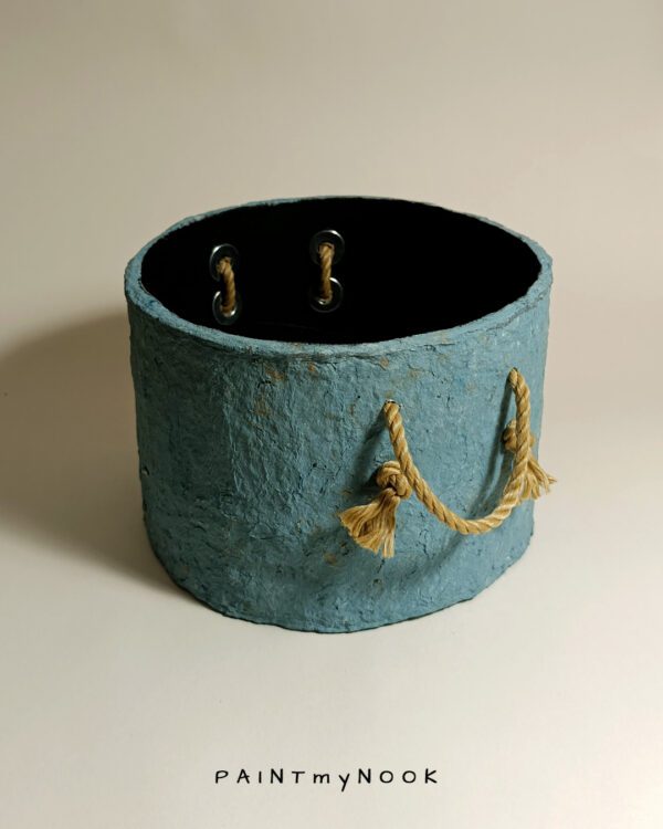 A sky blue colored planter cover