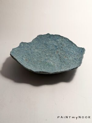 A papier mache bowl with an aquamarine color