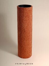 A brick red cylindrical vase