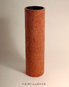 A brick red cylindrical vase