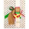 White orthogonal Easter candle with red, green and jute ribbon and a yellow chicken paper toy