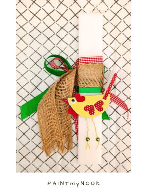 White orthogonal Easter candle with red, green and jute ribbon and a yellow chicken paper toy