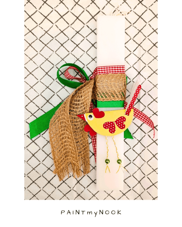 White orthogonal Easter candle with red, green and jute ribbon and a yellow chicken paper toy