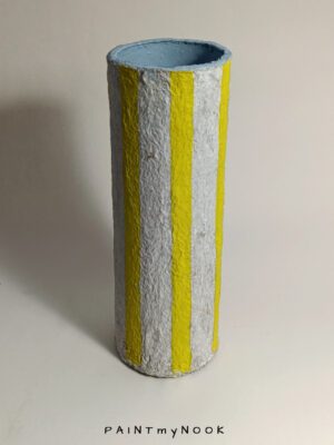 A handpainted papier mache vase, with lemon yellow stripes