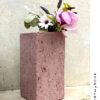 A dusty pink colored rectangular papier mache vase