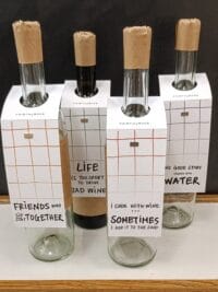 Four wine bottles with tags
